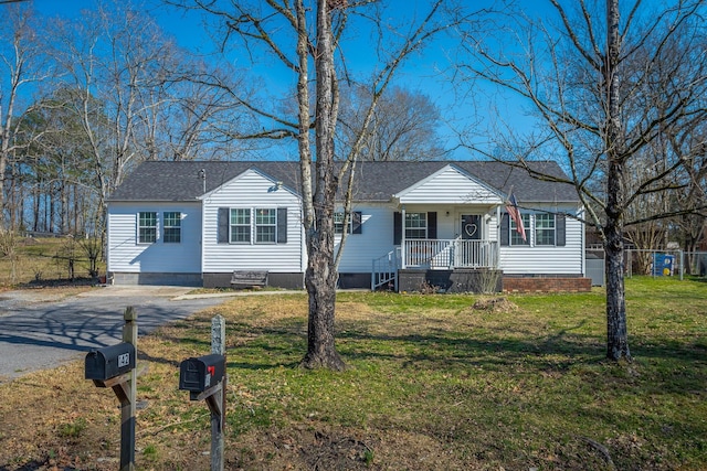 view of front of property featuring crawl space, a porch, a shingled roof, and a front lawn