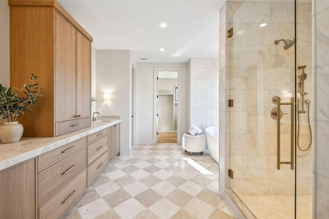 full bathroom featuring vanity, a freestanding tub, recessed lighting, a stall shower, and tile patterned floors