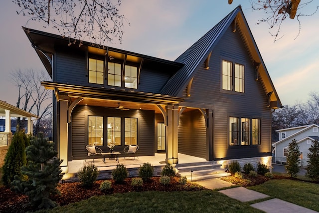 view of front of home with a porch and metal roof