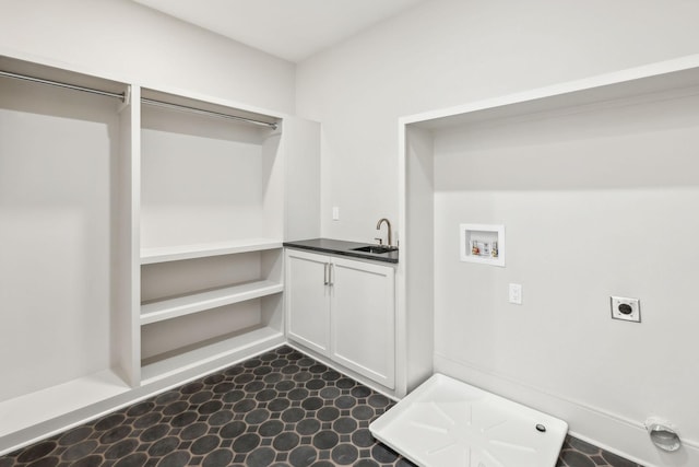 laundry room featuring washer hookup, a sink, dark floors, hookup for an electric dryer, and laundry area