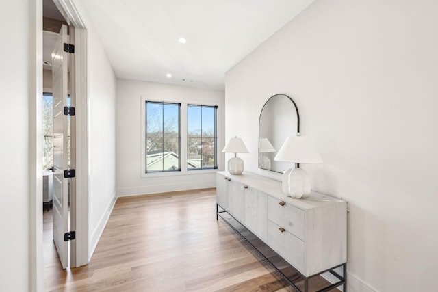 hall featuring recessed lighting, baseboards, and light wood-type flooring