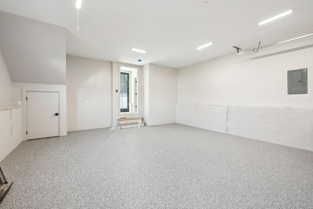 interior space with electric panel and concrete block wall