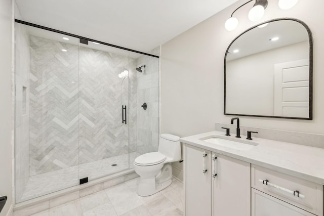 bathroom featuring toilet, a stall shower, and vanity