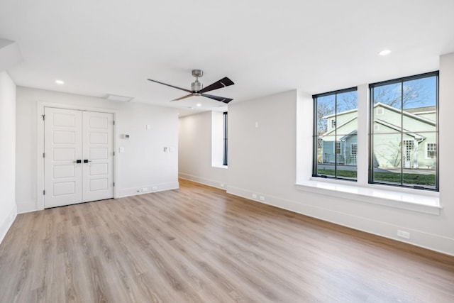 unfurnished living room with recessed lighting, light wood-style flooring, baseboards, and ceiling fan