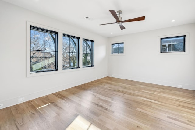 spare room with visible vents, a ceiling fan, wood finished floors, recessed lighting, and baseboards