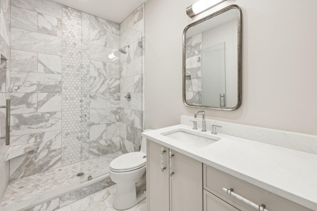 full bathroom featuring vanity, toilet, and a tile shower