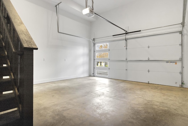 garage featuring a garage door opener and baseboards