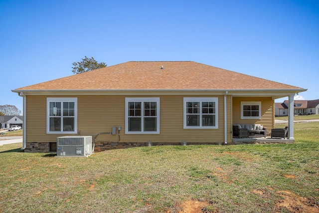 back of house featuring central air condition unit, a yard, a patio area, and a shingled roof