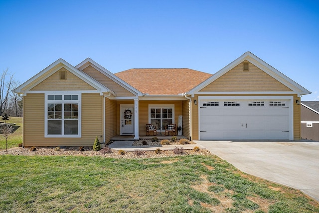 view of front of home with a garage, a porch, concrete driveway, and a front yard