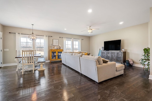 living room with recessed lighting, baseboards, dark wood finished floors, and ceiling fan with notable chandelier