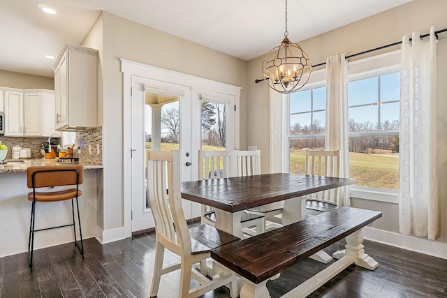 dining space with dark wood finished floors, a chandelier, recessed lighting, and baseboards