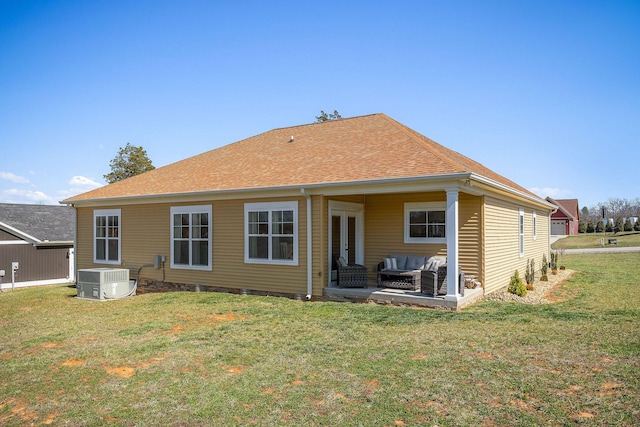 back of property with a lawn, central AC, french doors, an outdoor hangout area, and a patio area