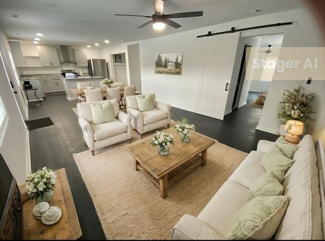 living room featuring visible vents, a barn door, recessed lighting, dark wood-style floors, and a ceiling fan