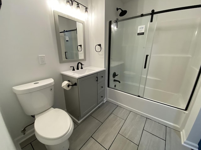 bathroom with vanity, toilet, and enclosed tub / shower combo