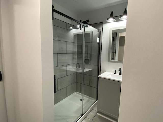 full bath with a stall shower and vanity