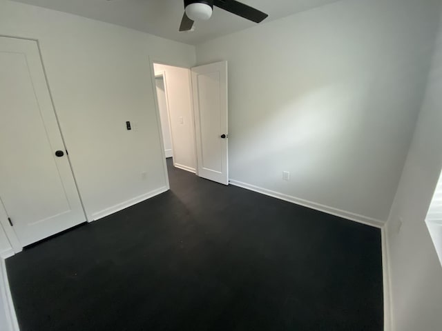 unfurnished bedroom with a ceiling fan and baseboards