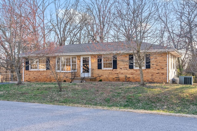 single story home with brick siding and a front lawn