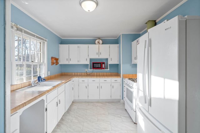 kitchen featuring white appliances, ornamental molding, light countertops, white cabinets, and marble finish floor