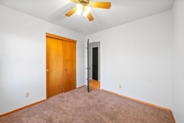 unfurnished bedroom with a closet, baseboards, a ceiling fan, and carpet flooring