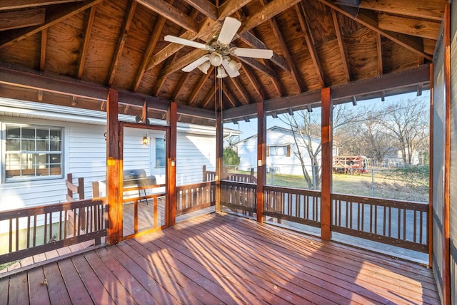 unfurnished sunroom featuring vaulted ceiling and a ceiling fan