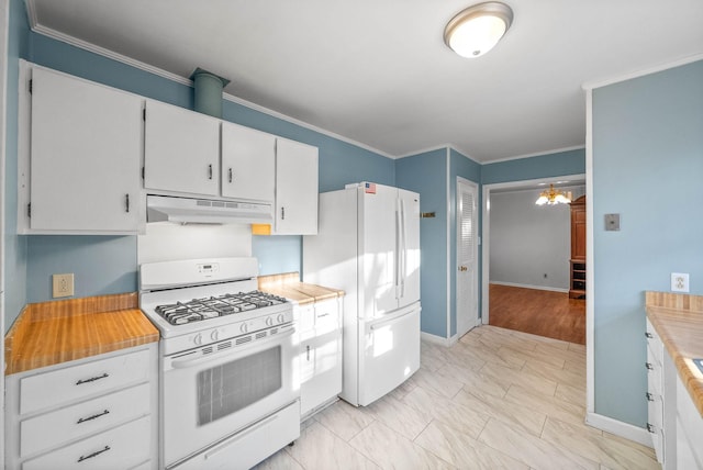 kitchen featuring under cabinet range hood, a notable chandelier, white appliances, and light countertops