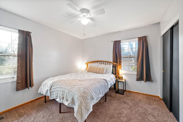 bedroom featuring a closet, visible vents, baseboards, and carpet floors