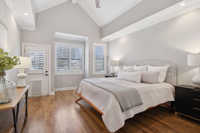 bedroom with recessed lighting, multiple windows, baseboards, and wood finished floors