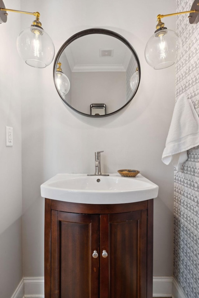 bathroom with visible vents, vanity, and crown molding