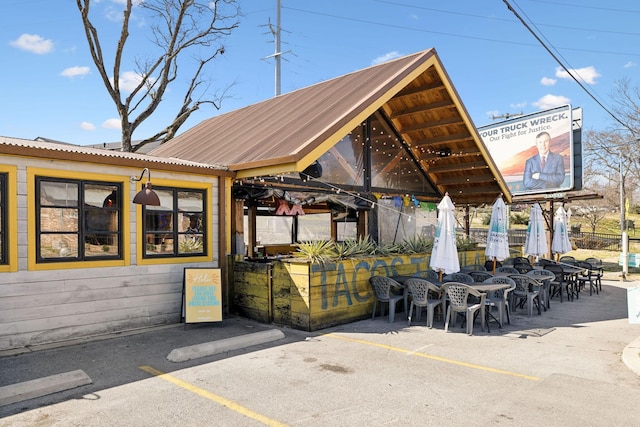 exterior space with a gazebo and outdoor dining area