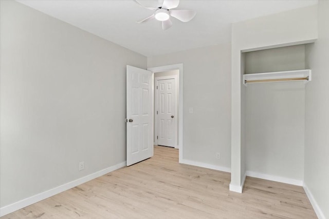 unfurnished bedroom with a closet, ceiling fan, baseboards, and wood finished floors