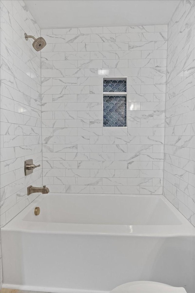 bathroom with shower / washtub combination