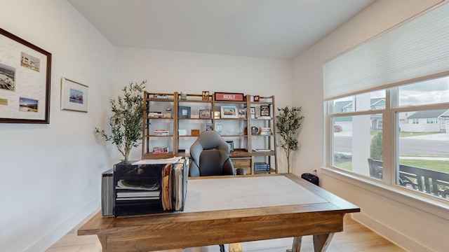 office area with wood finished floors and baseboards