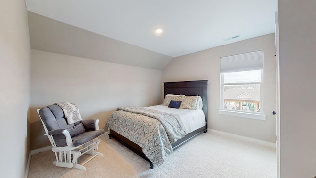 bedroom featuring lofted ceiling, light colored carpet, visible vents, and baseboards