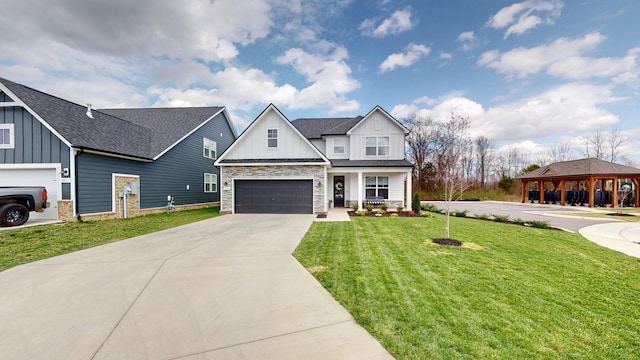 modern farmhouse featuring driveway, a front lawn, stone siding, board and batten siding, and a shingled roof