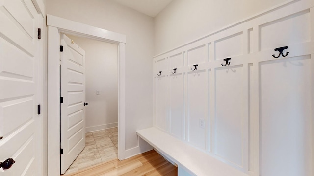 mudroom featuring light wood-style floors and baseboards