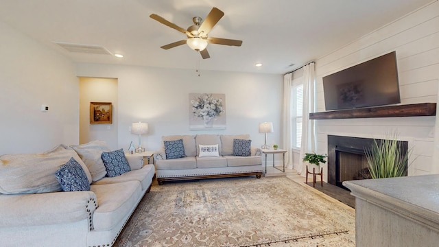 living area with recessed lighting, visible vents, a fireplace, and a ceiling fan