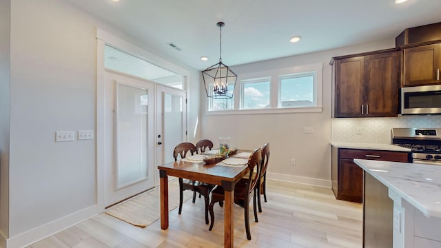 dining area featuring baseboards, visible vents, an inviting chandelier, light wood-style flooring, and recessed lighting