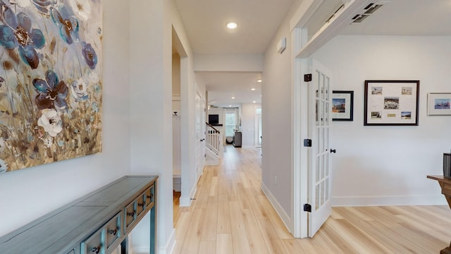 corridor featuring recessed lighting, light wood-type flooring, and baseboards