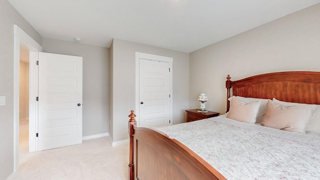 bedroom featuring baseboards and light carpet