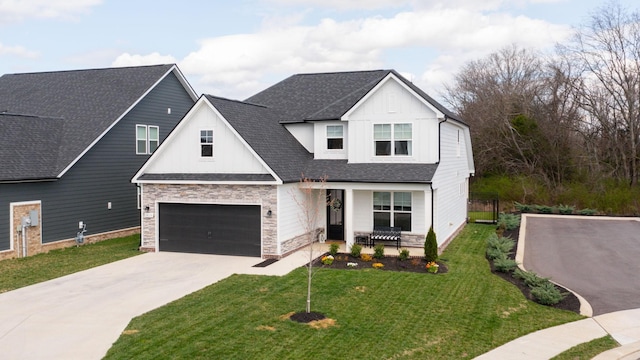 view of front of property with driveway, a front lawn, stone siding, roof with shingles, and board and batten siding