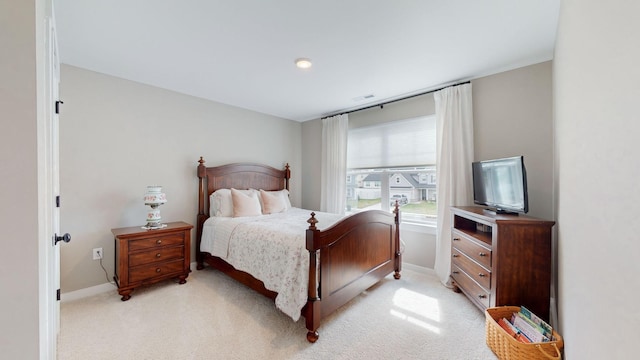 bedroom featuring light colored carpet, visible vents, and baseboards