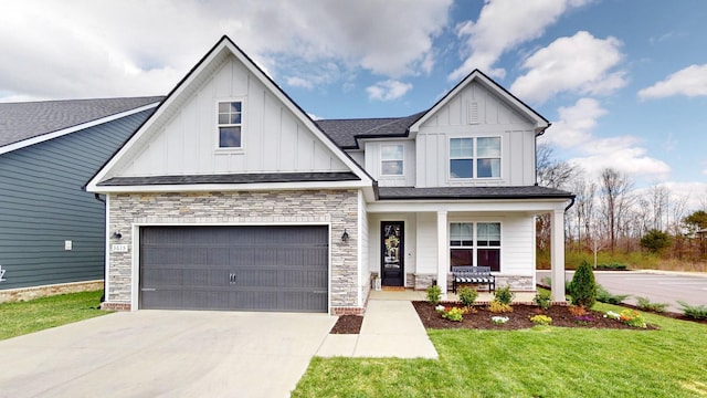 view of front of house featuring a porch, concrete driveway, board and batten siding, and stone siding