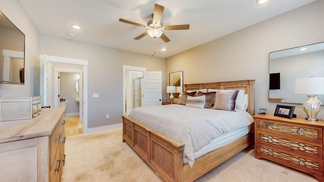 bedroom featuring light carpet, recessed lighting, baseboards, and connected bathroom