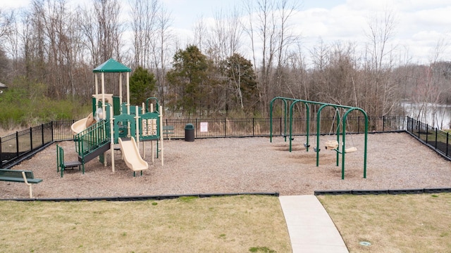 communal playground featuring a yard and fence