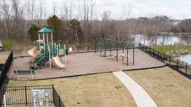 community jungle gym with fence, a lawn, and a water view