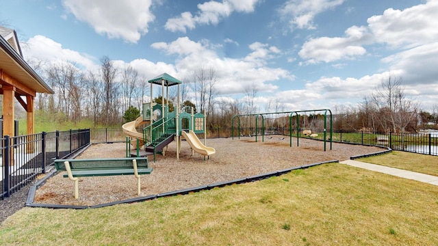 communal playground featuring a yard and fence