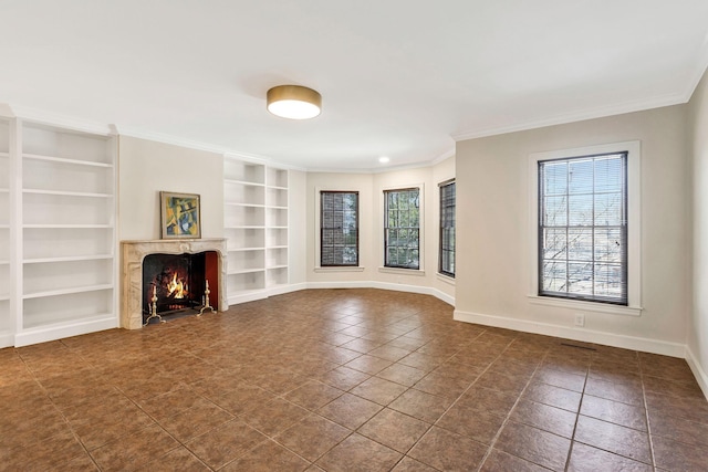 unfurnished living room with a wealth of natural light, a premium fireplace, baseboards, and built in features