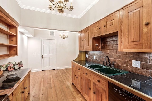 kitchen with light wood-type flooring, a sink, crown molding, baseboards, and a chandelier