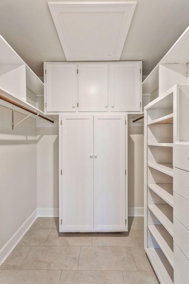 spacious closet with light tile patterned floors