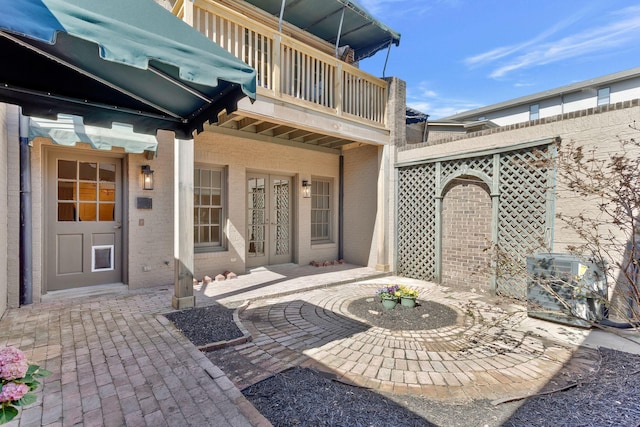 view of patio / terrace featuring french doors and a balcony